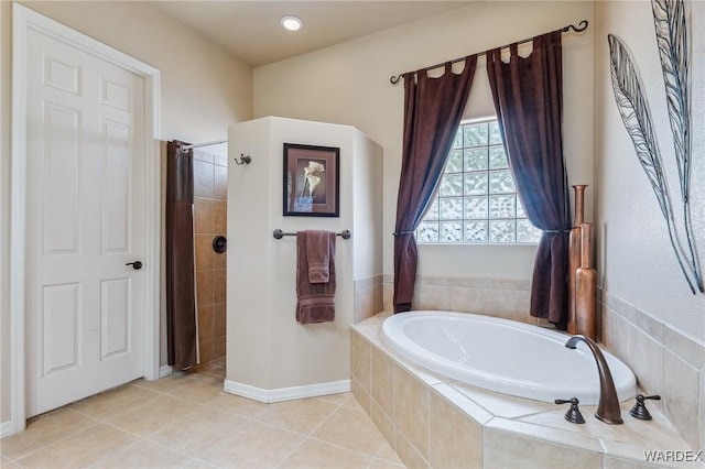 full bathroom featuring a shower stall, a bath, and tile patterned floors