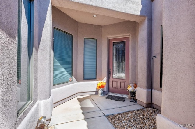 property entrance featuring stucco siding