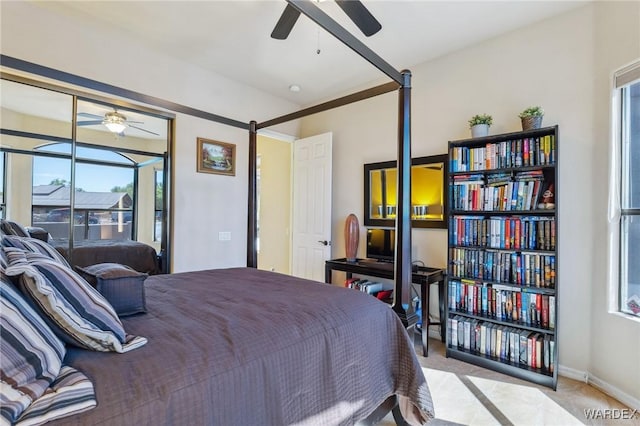 bedroom with baseboards and light colored carpet