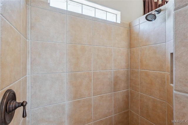 interior details with a tile shower