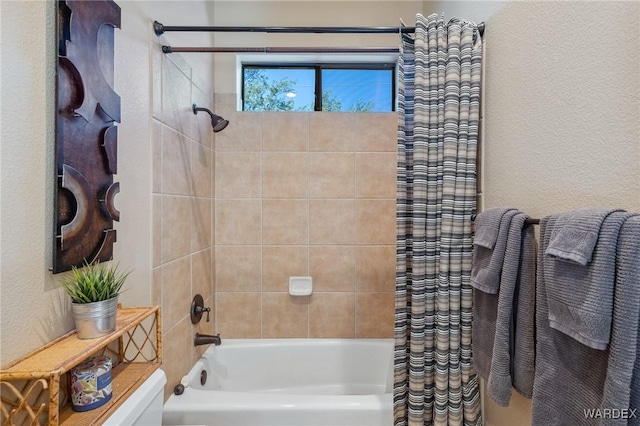 full bathroom featuring shower / tub combo and a textured wall