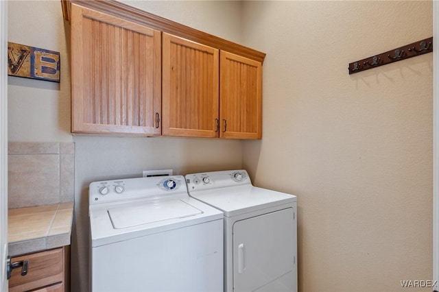 laundry area with cabinet space and independent washer and dryer