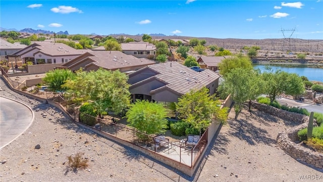 drone / aerial view featuring a residential view and a water and mountain view