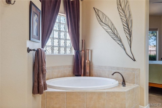 full bathroom featuring a garden tub and ensuite bath