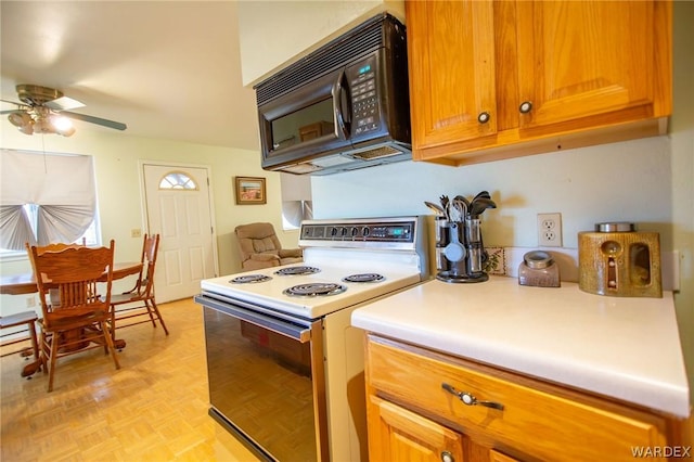 kitchen featuring black microwave, ceiling fan, light countertops, brown cabinets, and white electric range oven