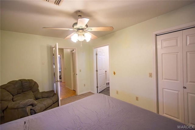 unfurnished bedroom featuring light carpet, baseboards, visible vents, a ceiling fan, and a closet