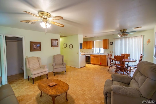 living room featuring visible vents and ceiling fan