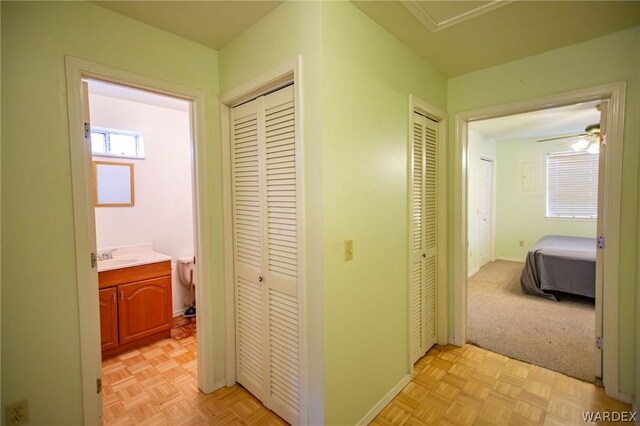 hallway featuring baseboards