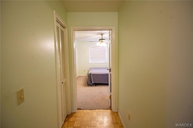 hall featuring baseboards