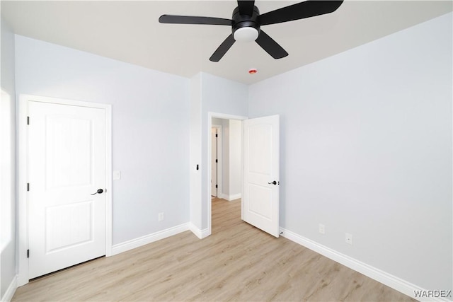 unfurnished bedroom featuring a ceiling fan, light wood-type flooring, and baseboards