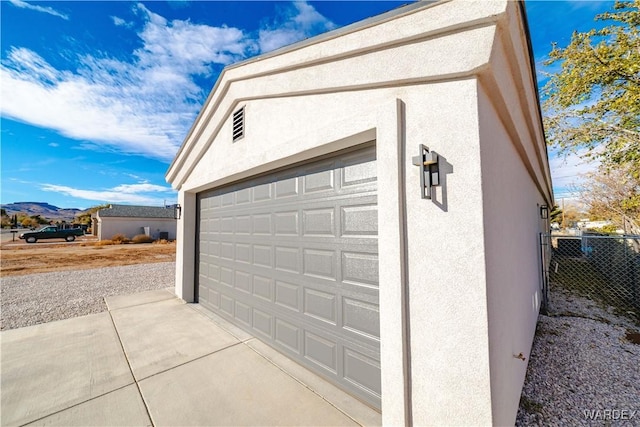 garage with fence and a mountain view