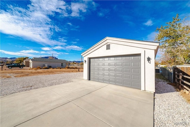 detached garage featuring fence