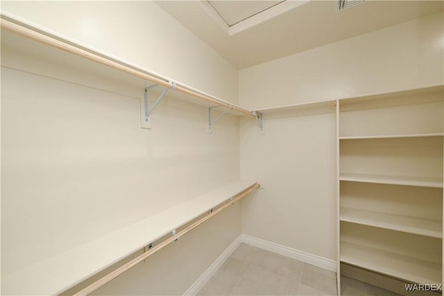 spacious closet featuring tile patterned floors