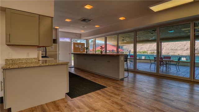 441 Moser Ave Unit B3, Bullhead City, AZ 86429 - kitchen featuring light wood-style floors and light stone countertops
