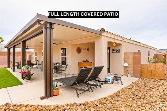 view of patio / terrace featuring a ceiling fan and fence