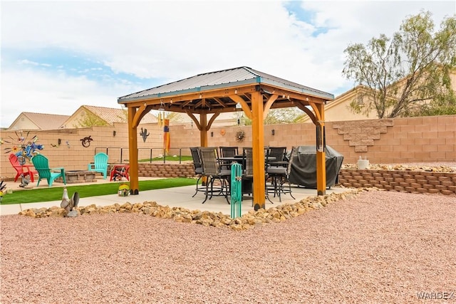 view of community featuring a gazebo, a fire pit, a patio, and fence