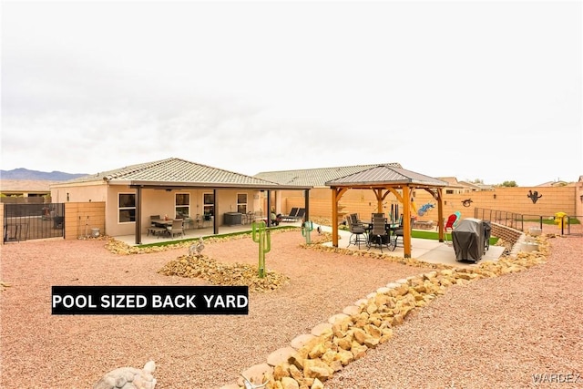 back of house featuring a gazebo, stucco siding, fence, and a patio area