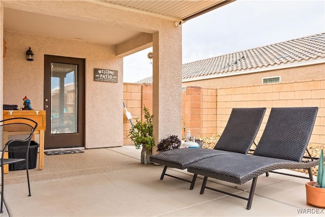 view of patio / terrace featuring visible vents and fence