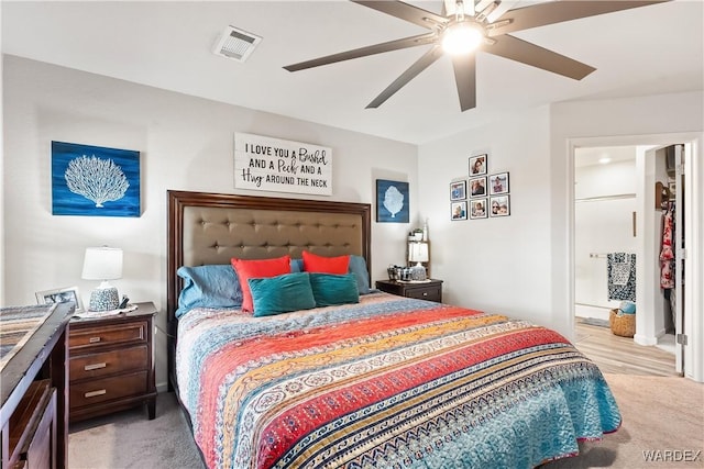 bedroom featuring visible vents, ceiling fan, and carpet floors