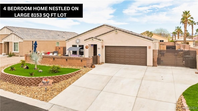 view of front of property with a tiled roof, concrete driveway, stucco siding, a garage, and a gate