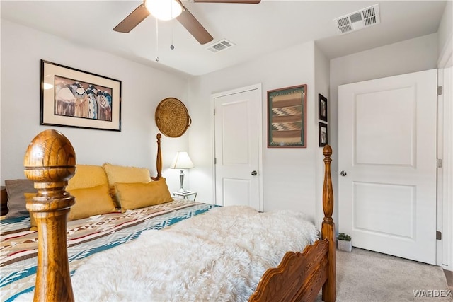 carpeted bedroom featuring visible vents and ceiling fan