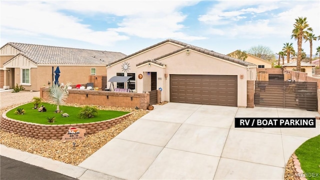 view of front of home featuring stucco siding, driveway, fence, an attached garage, and a tiled roof