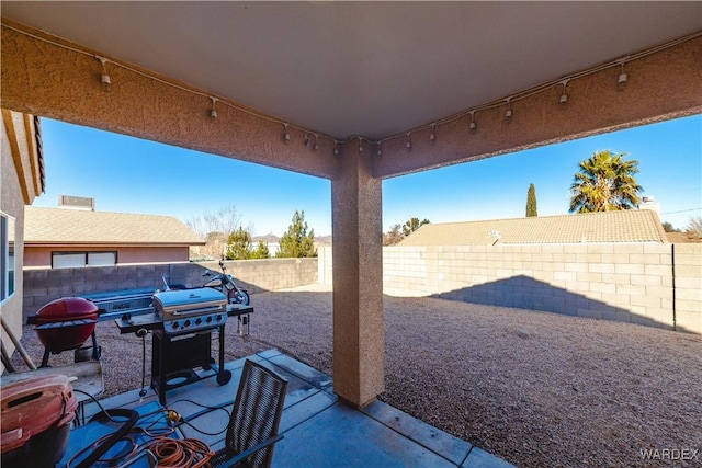 view of patio / terrace featuring a fenced backyard and a grill