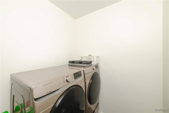 clothes washing area with laundry area and separate washer and dryer