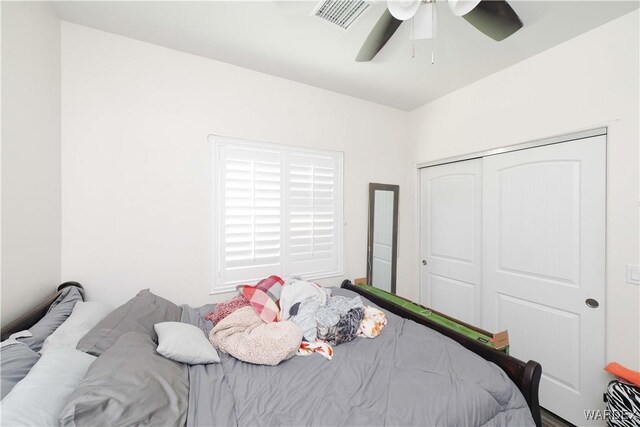 bedroom with a closet, visible vents, and a ceiling fan