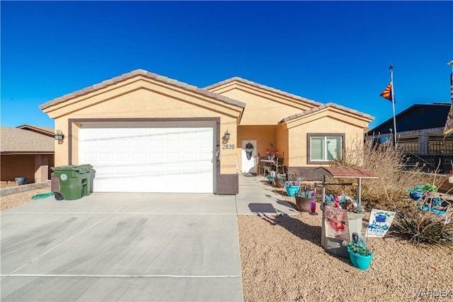 single story home with a garage, a tile roof, driveway, and stucco siding