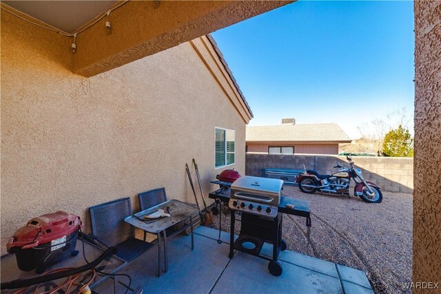 view of patio with a fenced backyard and a grill