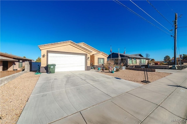 ranch-style house with a garage, concrete driveway, a tiled roof, and stucco siding