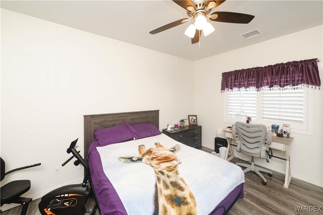 bedroom featuring visible vents, ceiling fan, and wood finished floors