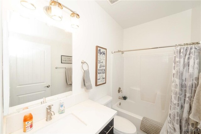 bathroom featuring visible vents, vanity, toilet, and shower / bathtub combination with curtain