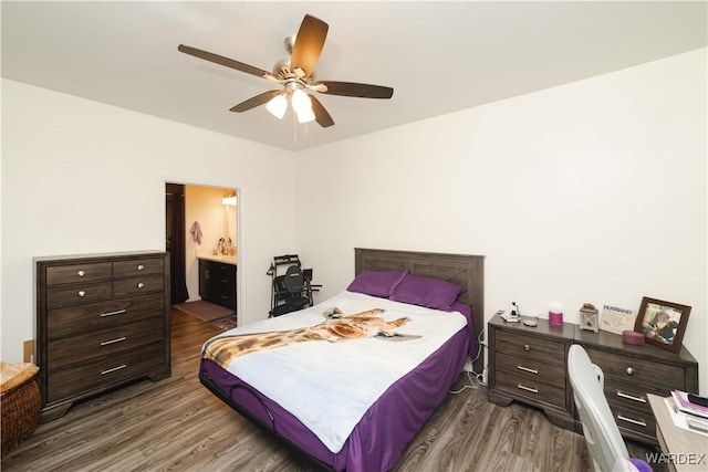 bedroom featuring dark wood-style floors, connected bathroom, and a ceiling fan