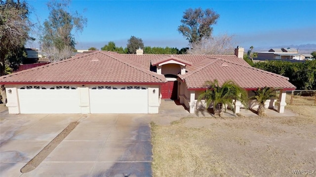 ranch-style house with a tile roof, a chimney, stucco siding, concrete driveway, and an attached garage