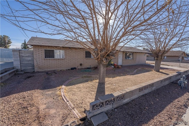 single story home with brick siding and fence