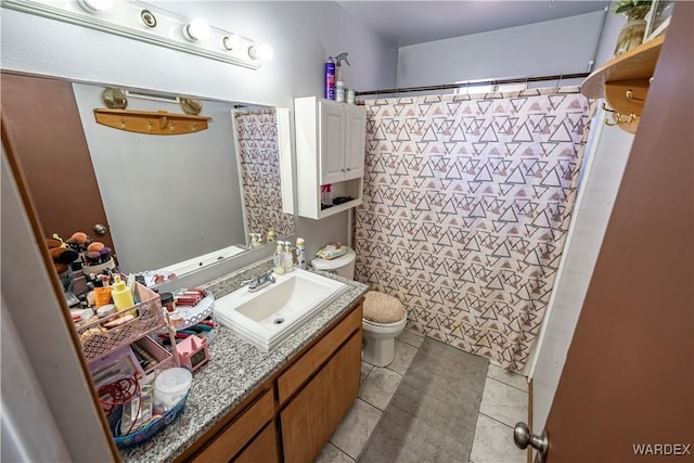 bathroom featuring a shower with curtain, vanity, toilet, and tile patterned floors