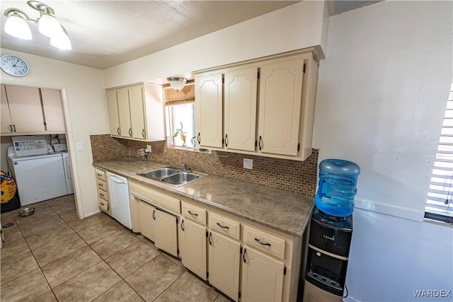 kitchen featuring a sink, light countertops, backsplash, dishwasher, and washing machine and clothes dryer