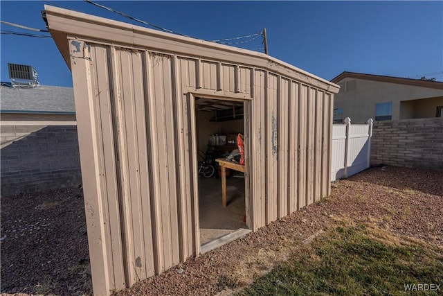 view of shed featuring fence