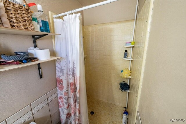 bathroom with tiled shower