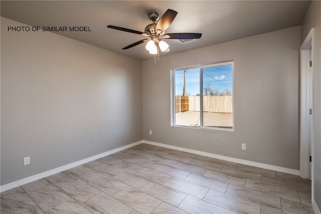 unfurnished room with baseboards and ceiling fan