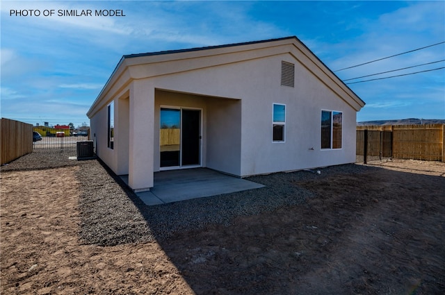 back of house featuring a fenced backyard, a patio, stucco siding, and cooling unit