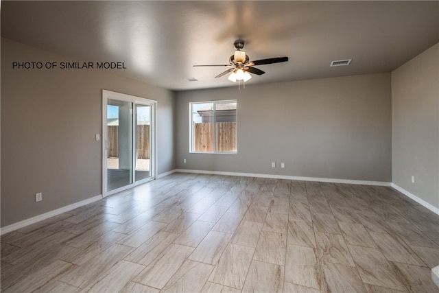 empty room featuring visible vents, baseboards, and a ceiling fan