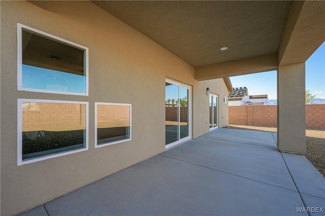 view of patio featuring fence