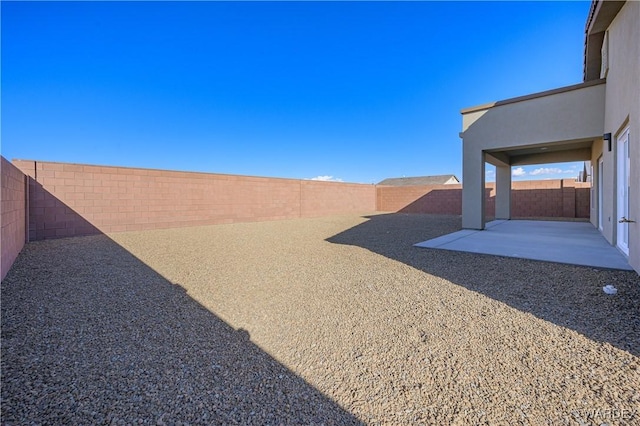 view of yard featuring a patio area and a fenced backyard