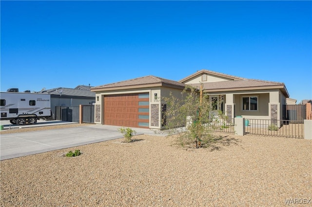 view of front facade with an attached garage, fence, concrete driveway, and stucco siding