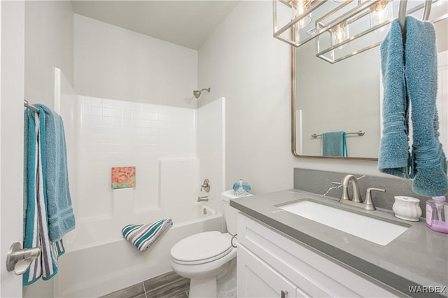 bathroom with  shower combination, vanity, and toilet