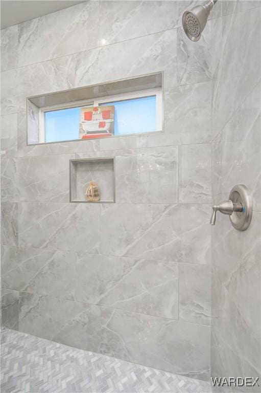 full bath with a tile shower