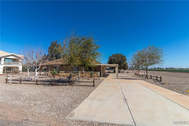 view of front of home featuring an attached carport and driveway